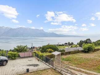 Enjoy breathtaking panoramic views of the lake and mountains from this stunning property.