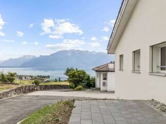Experience breathtaking panoramic views of the lake and majestic mountains from this stunning property.