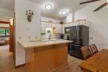 Discover this charming kitchen featuring ample white cabinetry and a sleek stainless steel refrigerator.