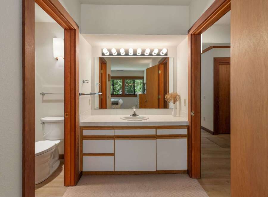This bathroom features a spacious vanity with ample counter space and storage, perfect for organizing your essentials.