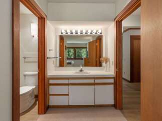This bathroom features a spacious vanity with ample counter space and storage, perfect for organizing your essentials.
