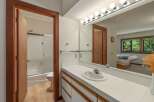 This bathroom features a spacious vanity with a tiled countertop and ample storage, perfect for organizing your essentials.