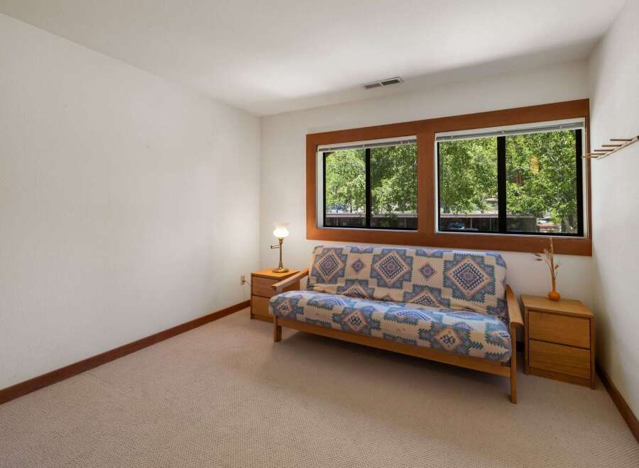 This cozy room features a comfortable futon with a vibrant geometric pattern, perfect for relaxing.