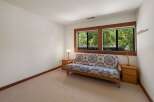 This cozy room features a comfortable futon with a vibrant geometric pattern, perfect for relaxing.