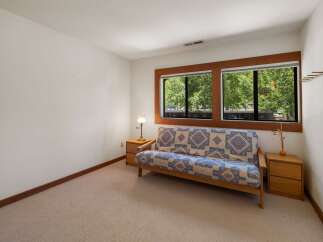 This cozy room features a comfortable futon with a vibrant geometric pattern, perfect for relaxing.