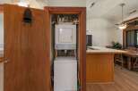 Discover convenient in-unit laundry facilities with this stacked washer and dryer, neatly tucked away in a closet.
