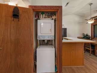Discover convenient in-unit laundry facilities with this stacked washer and dryer, neatly tucked away in a closet.