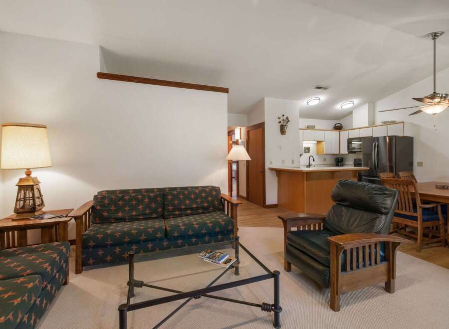 This inviting living space features a comfortable sofa and armchair, perfect for relaxing after a day of adventure.