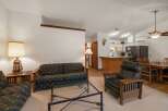 This inviting living space features a comfortable sofa and armchair, perfect for relaxing after a day of adventure.