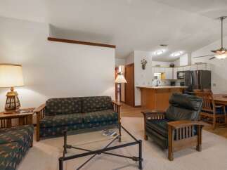 This inviting living space features a comfortable sofa and armchair, perfect for relaxing after a day of adventure.