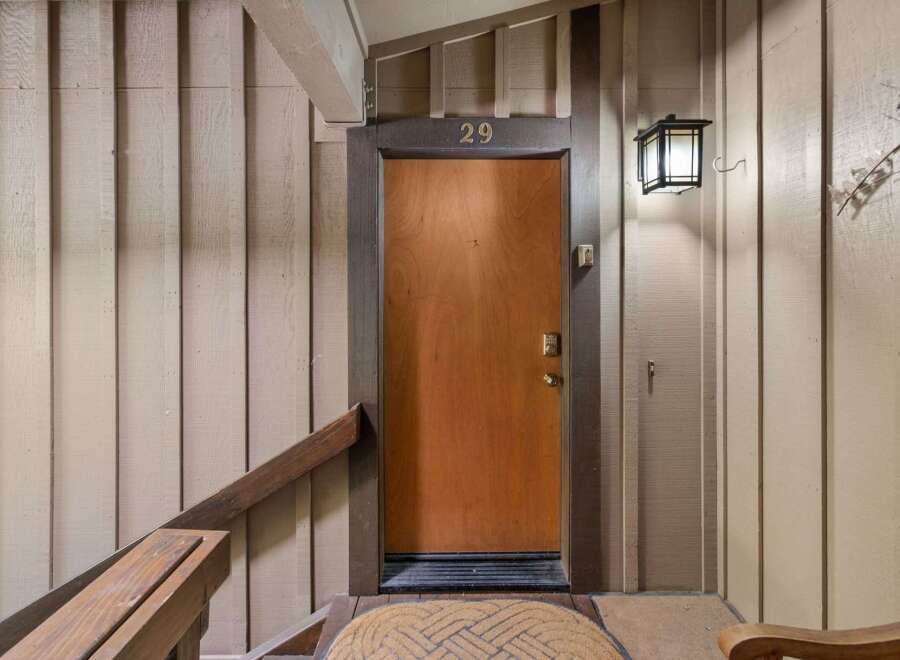 Welcome to unit 29, featuring a warm and inviting wooden door with a modern digital lock for enhanced security.