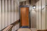 Welcome to unit 29, featuring a warm and inviting wooden door with a modern digital lock for enhanced security.