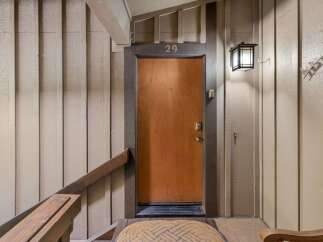 Welcome to unit 29, featuring a warm and inviting wooden door with a modern digital lock for enhanced security.