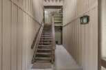 Ascend to new heights in this charming property featuring a rustic wooden staircase leading to the upper levels.