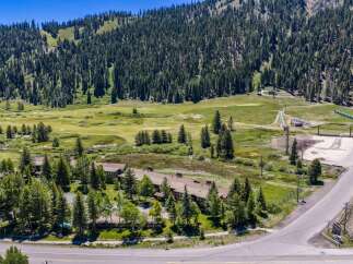 Discover this stunning property nestled amidst a lush forest, offering breathtaking mountain views and a serene golf course setting.