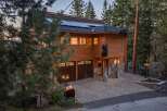 Experience the unique charm of this mountain retreat, featuring a striking wooden exterior and playful bear decorations.