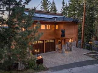 Experience the unique charm of this mountain retreat, featuring a striking wooden exterior and playful bear decorations.