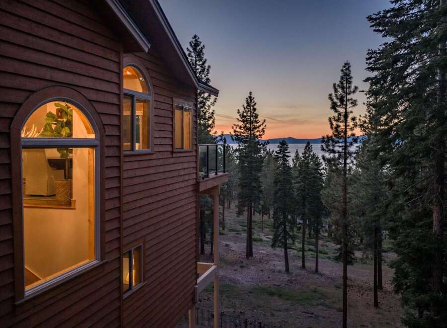 Experience breathtaking sunset views from this stunning property, nestled amidst a serene forest landscape.