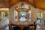 Experience breathtaking lake and mountain views from this stunning kitchen, featuring a large granite island and ample custom cabinetry.