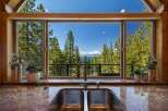 Experience breathtaking lake and mountain views from this stunning kitchen, featuring a large double sink and a modern faucet.