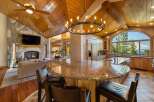 Experience luxury living in this stunning open-concept home, featuring a grand stone fireplace and a spacious kitchen with a large granite island perfect for entertaining.