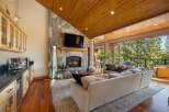 Experience luxury living in this stunning mountain retreat, featuring a grand stone fireplace and a beautifully appointed wet bar perfect for entertaining.