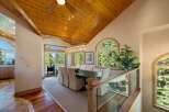 Experience breathtaking views from this stunning dining room, featuring a large wooden table with upholstered chairs, perfect for hosting memorable meals.