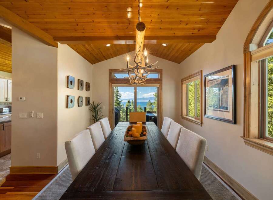 Experience breathtaking lake and mountain views from this stunning dining room, perfect for entertaining.