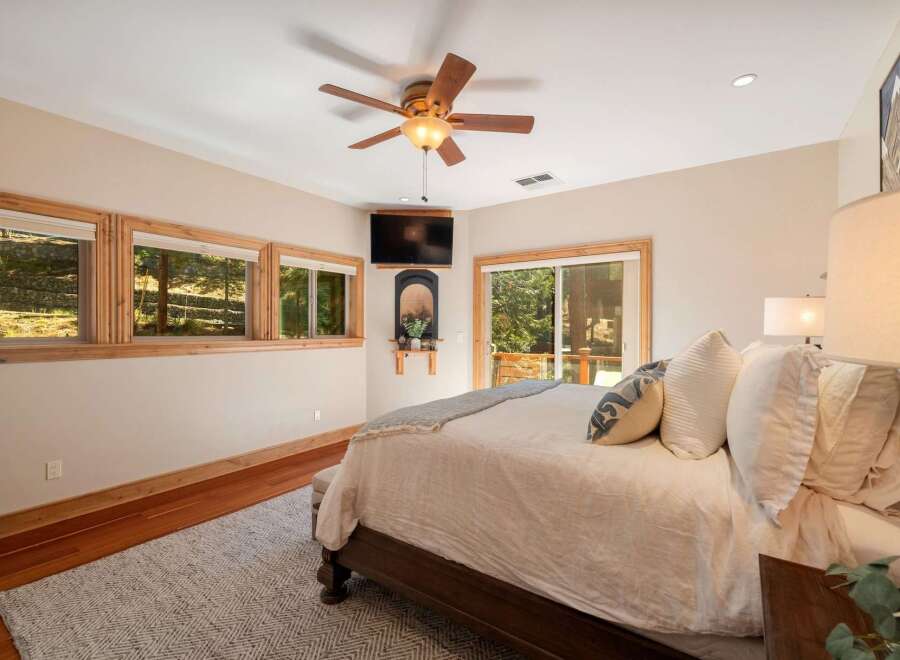 Experience serene living in this beautifully appointed bedroom, featuring a cozy king-size bed adorned with plush linens and decorative pillows.