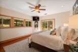 Experience serene living in this beautifully appointed bedroom, featuring a cozy king-size bed adorned with plush linens and decorative pillows.