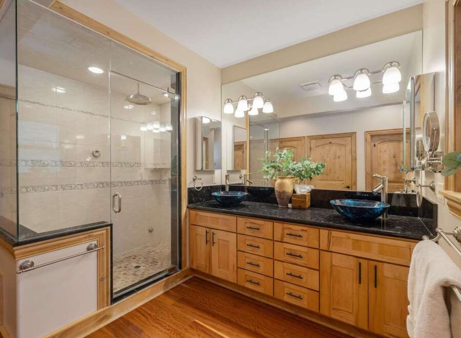 Experience luxury in this stunning bathroom featuring a spacious glass-enclosed shower with elegant tilework.