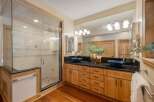Experience luxury in this stunning bathroom featuring a spacious glass-enclosed shower with elegant tilework.