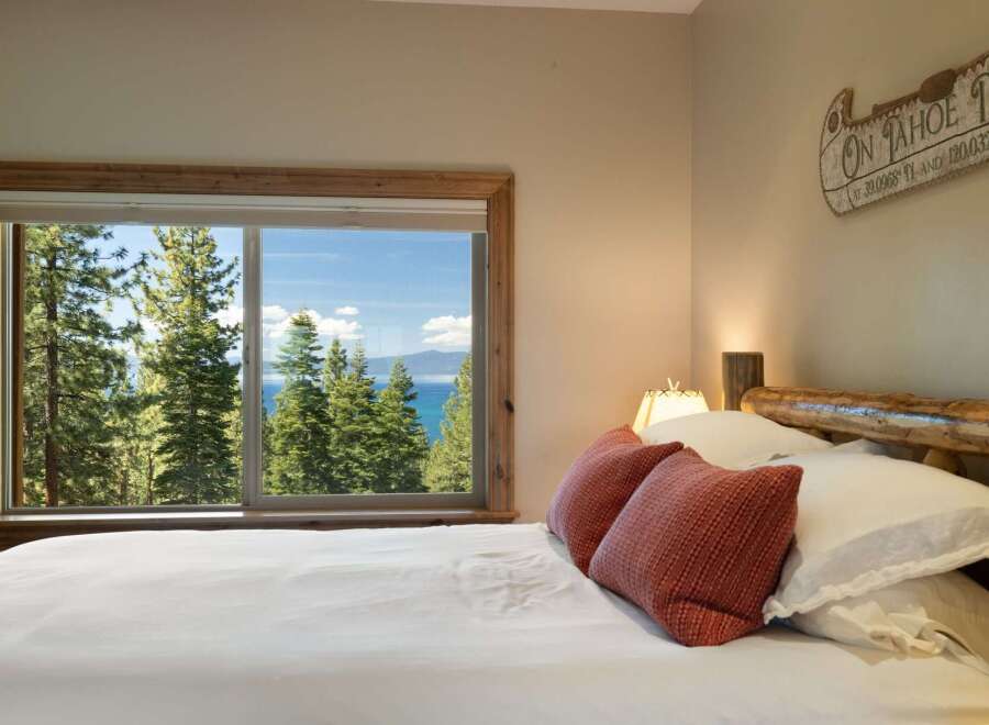 Wake up to breathtaking lake and mountain views from this serene bedroom.