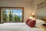 Wake up to breathtaking lake and mountain views from this serene bedroom.