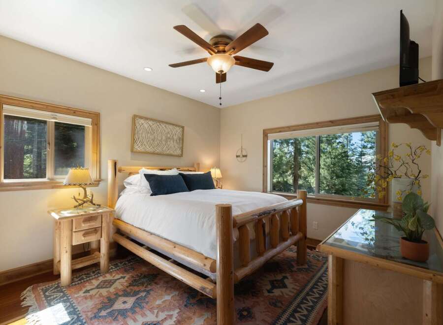Experience rustic charm in this cozy bedroom, featuring a sturdy log bed and a warm, inviting atmosphere.