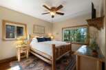 Experience rustic charm in this cozy bedroom, featuring a sturdy log bed and a warm, inviting atmosphere.