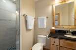 This modern bathroom features a sleek glass-enclosed shower with stylish tile work and a rainfall showerhead.