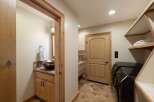 This spacious laundry room features a convenient half-bathroom, perfect for quick cleanups.