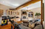 Experience ultimate relaxation and entertainment in this stunning living space, featuring a cozy stone fireplace and a large, comfortable sectional sofa perfect for gatherings.