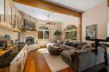 Experience cozy living with this stunning living room featuring a stone fireplace and a large sectional sofa perfect for relaxation.