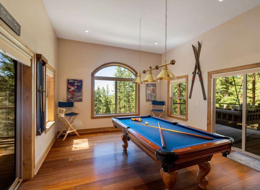 Experience ultimate relaxation and entertainment in this stunning game room, featuring a classic billiards table perfect for friendly competitions.