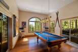 Experience ultimate relaxation and entertainment in this stunning game room, featuring a classic billiards table perfect for friendly competitions.