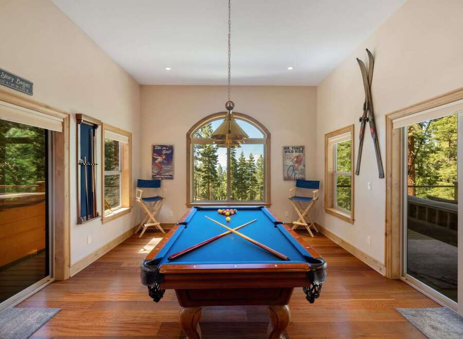 Experience ultimate relaxation and entertainment in this stunning game room, featuring a professional billiard table perfect for friendly competitions.