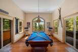 Experience ultimate relaxation and entertainment in this stunning game room, featuring a professional billiard table perfect for friendly competitions.