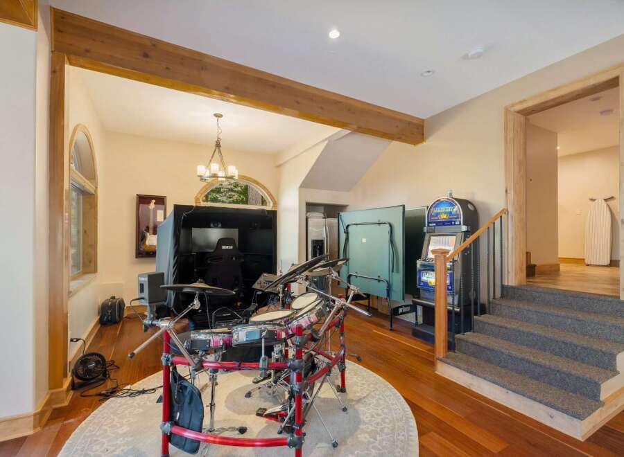 This entertainment room offers a variety of fun activities, including a digital drum set and arcade games.