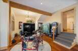 This entertainment room offers a variety of fun activities, including a digital drum set and arcade games.
