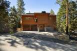 Discover this charming mountain home featuring a rustic wood exterior and a unique bear-themed facade, perfect for a nature lover's retreat.