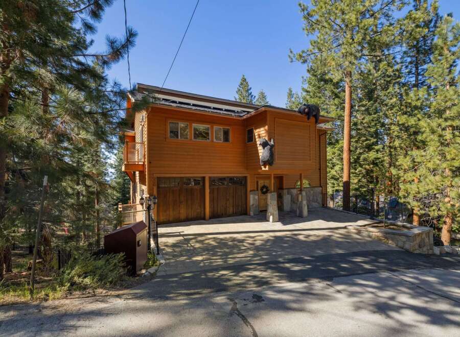 Nestled amongst towering pine trees, this charming wooden home offers a unique mountain retreat.