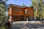 Experience the unique charm of this mountain retreat, featuring a striking wooden exterior adorned with playful bear sculptures.