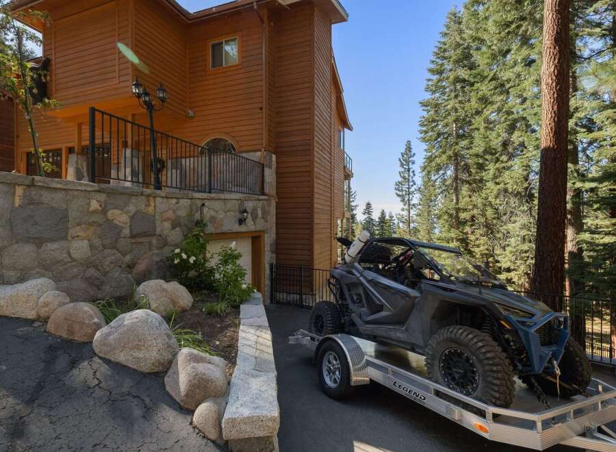 Experience the ultimate mountain lifestyle with this stunning property, featuring a beautiful wooden exterior and a robust stone foundation.